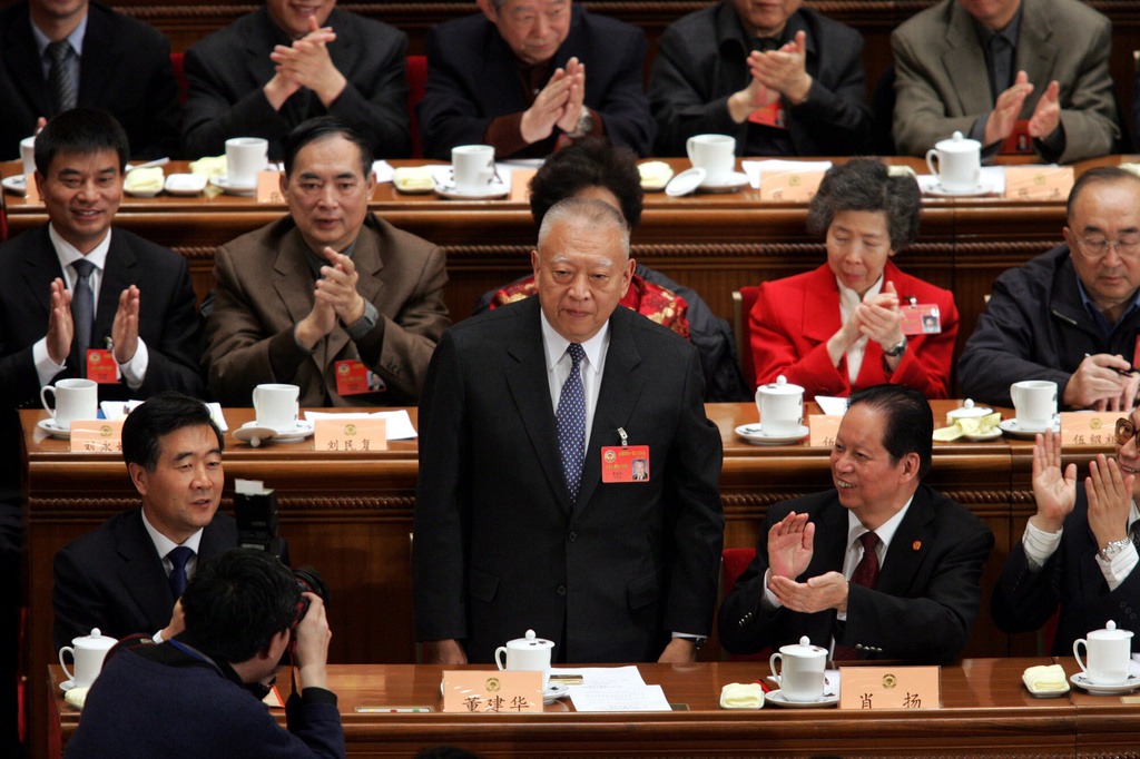 FILE - Hong Kong Chief Executive Tung Chee-hwa stands to acknowledge the applause of his colleagues after he was named a vice chairman of the Chinese People's Political Consultative Conference (CPPCC) during a closing ceremony held at the Great Hall of the People in Beijing, March 12, 2005. (AP Photo/Ng Han Guan, File)