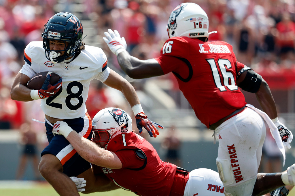 FILE - Virginia running back Noah Vaughn (28) runs the ball against North Carolina State during the first half of an NCAA college football game in Raleigh, N.C., Sept. 6, 2025. (AP Photo/Karl DeBlaker, File)