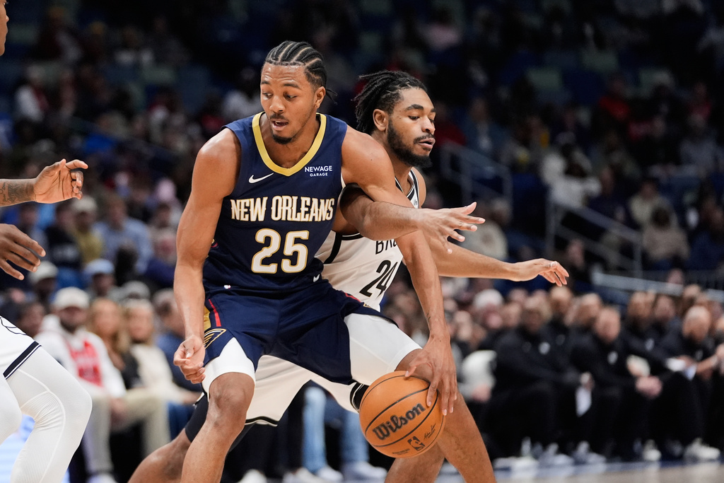 New Orleans Pelicans forward Trey Murphy III (25) dribbles against Brooklyn Nets guard Cam Thomas (24) in the first half of an NBA basketball game, Wednesday, Jan. 14, 2026, in New Orleans. (AP Photo/Gerald Herbert)