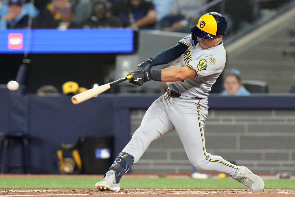 Milwaukee Brewers' Isaac Collins hits a two-run double against the Toronto Blue Jays during sixth-inning baseball game action in Toronto, Friday, Aug. 29, 2025. (Chris Young/The Canadian Press via AP)