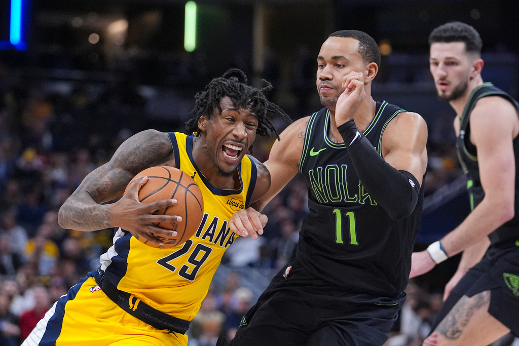 Indiana Pacers guard Quenton Jackson (29) is fouled by New Orleans Pelicans guard Bryce McGowens (11) during the second half of an NBA basketball game in Indianapolis, Friday, Jan. 16, 2026. (AP Photo/Michael Conroy)