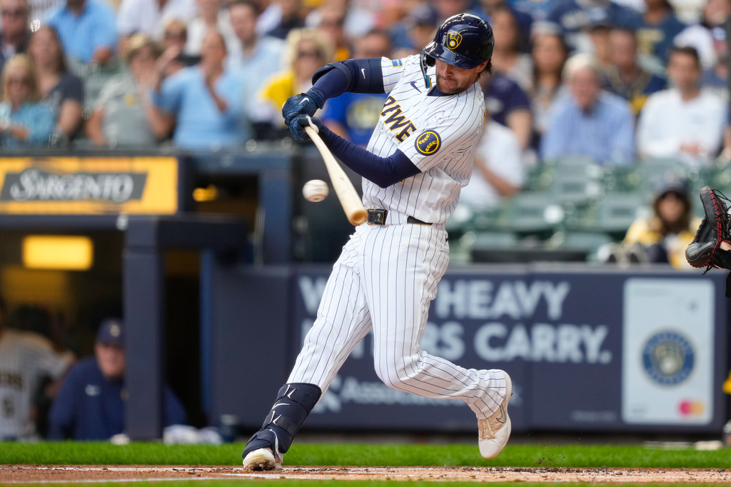 Milwaukee Brewers' Brice Turang hits an RBI single, allowing Jake Bauers, to score during the first inning of a baseball game against the St. Louis Cardinals, Sunday, Sept. 27, 2026, in Milwaukee. (AP Photo/Kayla Wolf)