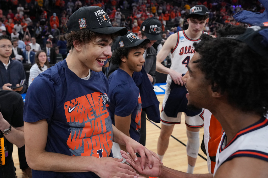 Illinois' Keaton Wagler, left, celebrates with a teammate after Illinois beat Iowa in an Elite Eight game in the NCAA college basketball tournament Saturday, March 28, 2026, in Houston. (AP Photo/Eric Gay)