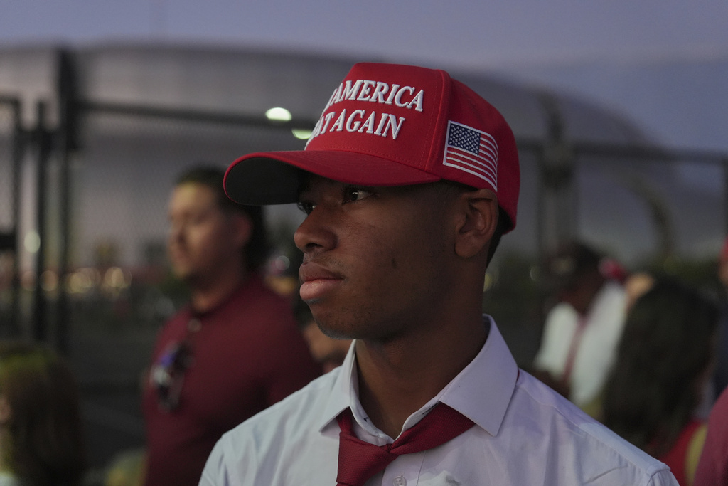 Bryson Levy waits in line before a memorial for conservative activist Charlie Kirk Sunday, Sept. 21, 2025, at State Farm Stadium in Glendale, Ariz. (AP Photo/Jae C. Hong)
