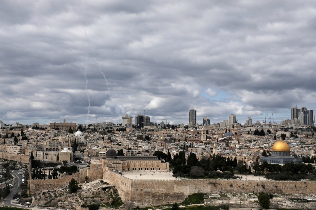 Traces of an air defense missile interception are seen, left, over Jerusalem's Old City, Saturday, Feb. 28, 2026. (AP Photo/Mahmoud Illean)