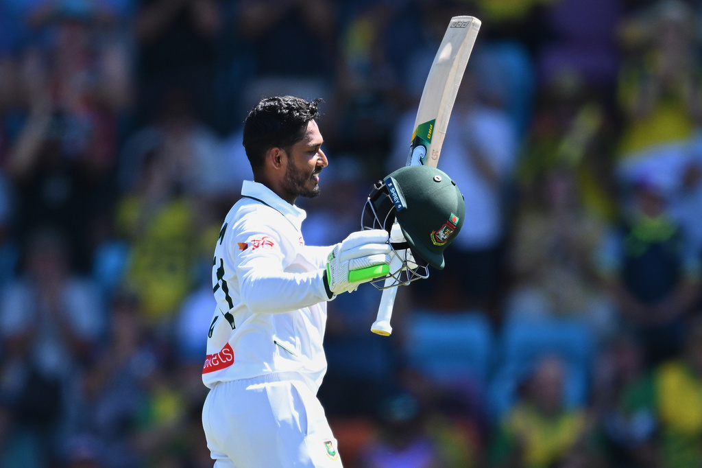 Tanzid Hasan Tamid of Bangladesh celebrates scoring a century against Australia during play on day two of the first cricket test in Darwin, Australia, Friday, Aug.14, 2026. (James Ross/AAPImage via AP)