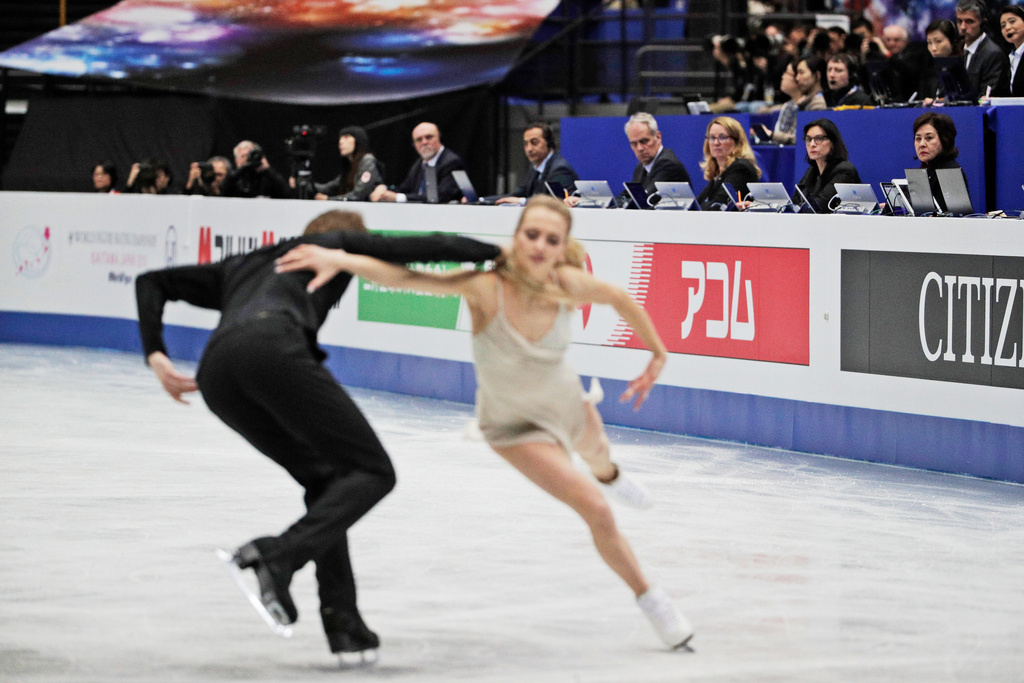 FILE - Judges watch Russia's Victoria Sinitsina and Nikita Katsalapov perform their ice dance free dance during the ISU World Figure Skating Championships at Saitama Super Arena in Saitama, north of Tokyo, March 23, 2019. (AP Photo/Andy Wong, File)
