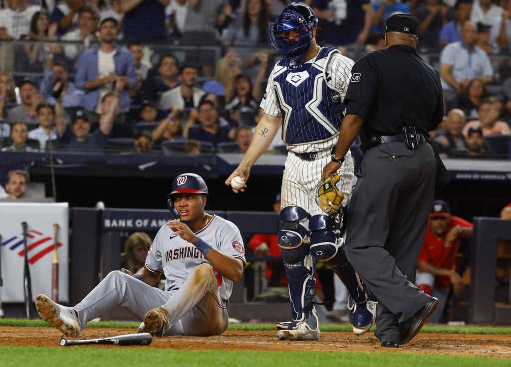 Washington Nationals' James Wood reacts after being tagged out by New York Yankees catcher Austin Wells during the fifth inning of a baseball game, Tuesday, Aug. 26, 2025, in New York. (AP Photo/Noah K. Murray)