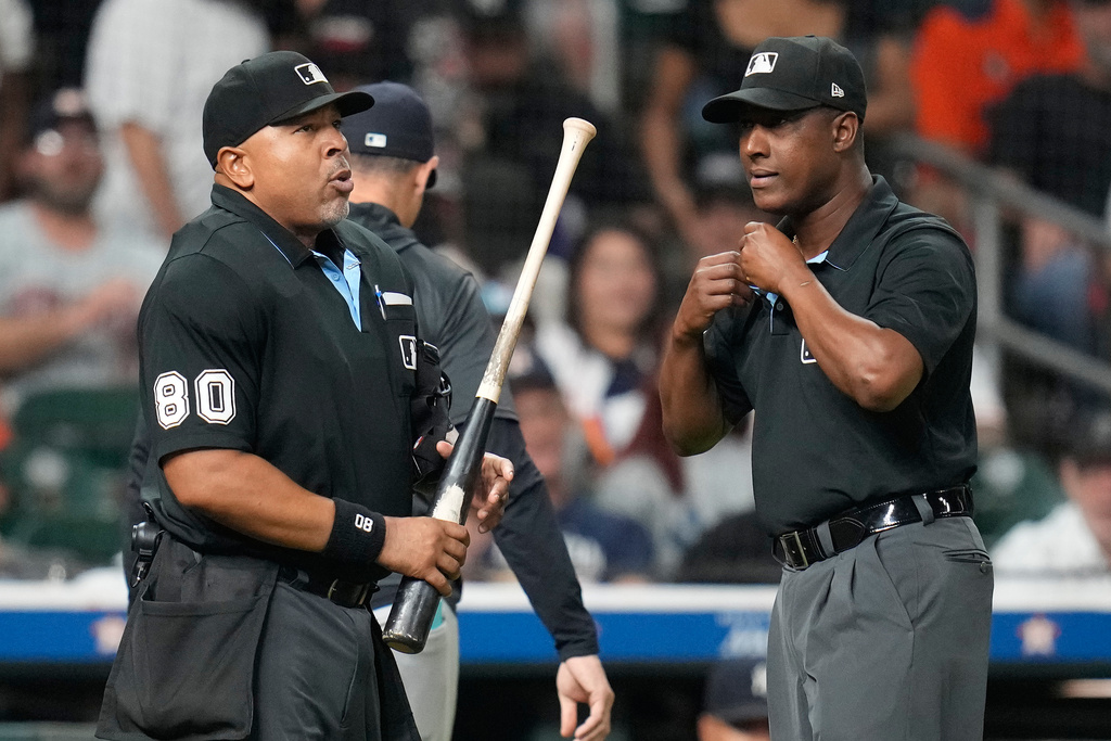 Home plate umpire Adrian Johnson, left, holds Houston Astros' Taylor Trammell's bat as he and Ramon De Jesus, right, were asked by the New York Yankees to challenge the bat during the ninth inning of a baseball game Thursday, Sept. 4, 2025, in Houston. (AP Photo/Karen Warren)