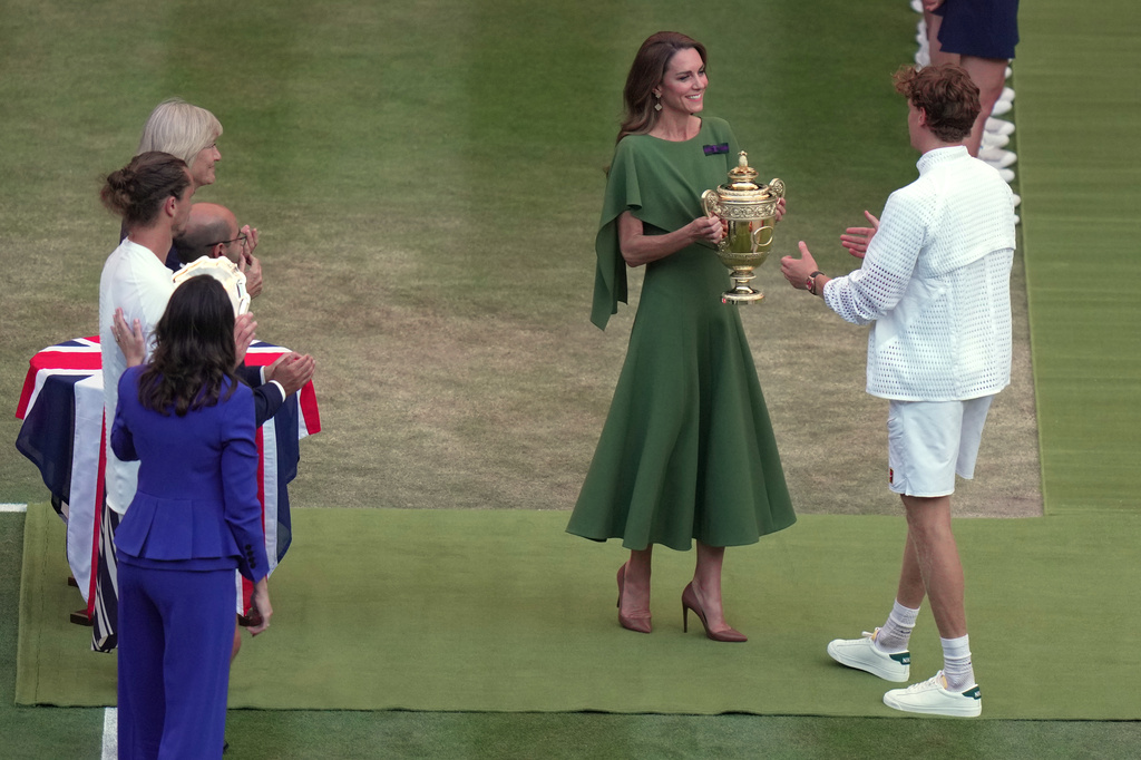 Britain's Princess Kate presents the champion trophy to Jannik Sinner of Italy after winning against Alexander Zverev of Germany in the men's singles final at Wimbledon Tennis Championships in London, Sunday, July 12, 2026. (AP Photo/Brian Inganga)