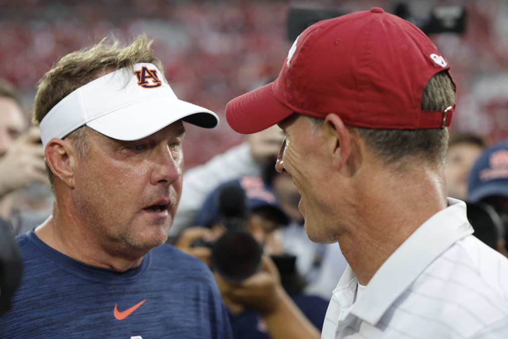 Auburn head coach Hugh Freeze and Oklahoma head coach Brent Venables meet mid field after an NCAA college football game Saturday, Sept. 20, 2025, in Norman, Okla. (AP Photo/Alonzo Adams)