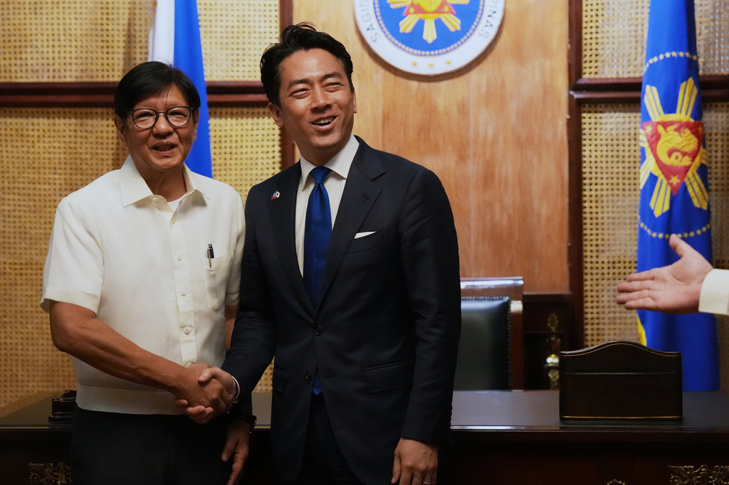 Philippine President Ferdinand Marcos Jr., left, greets Japan's Defense Minister Shinjiro Koizumi at the Malacanang presidential palace in Manila, Philippines on Tuesday, May 5, 2026. (AP Photo/Aaron Favila, Pool)