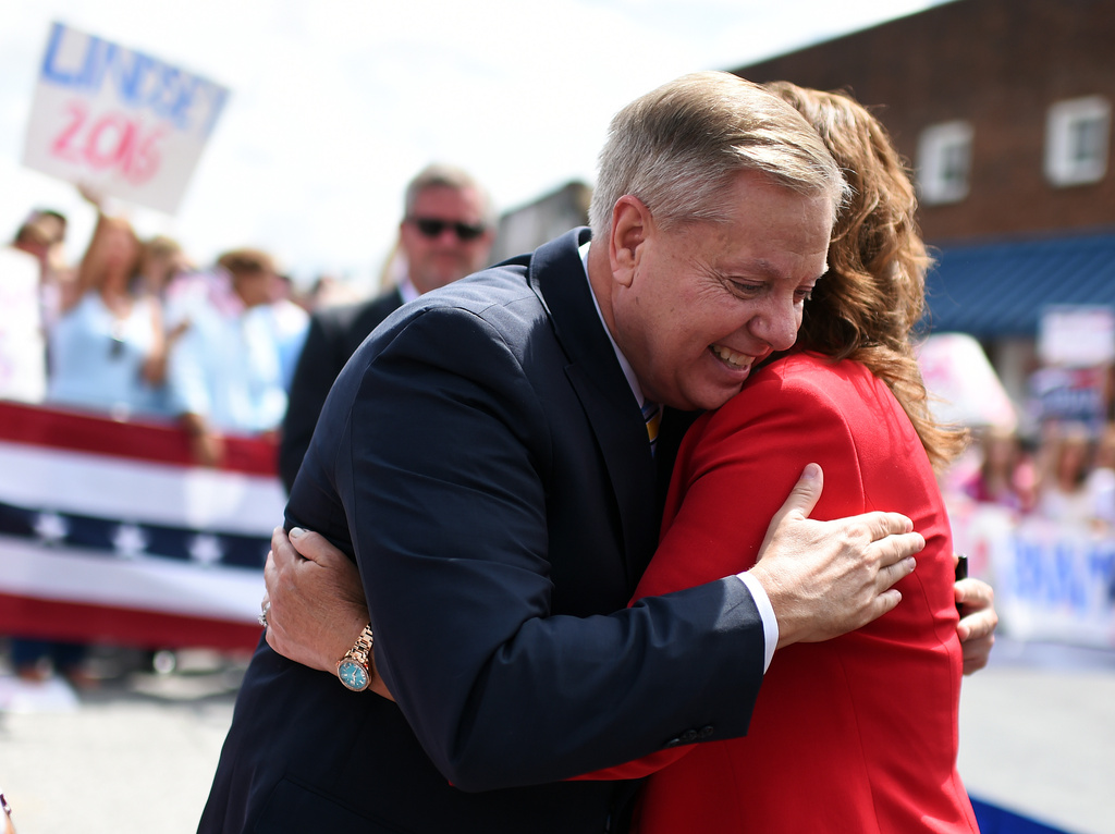 FILE - Sen. Lindsey Graham, R-S.C., left, hugs his sister Darline Graham Nordone, after announcing his bid for presidency, June 1, 2015, in Central, S.C. (AP Photo/Rainier Ehrhardt, File)