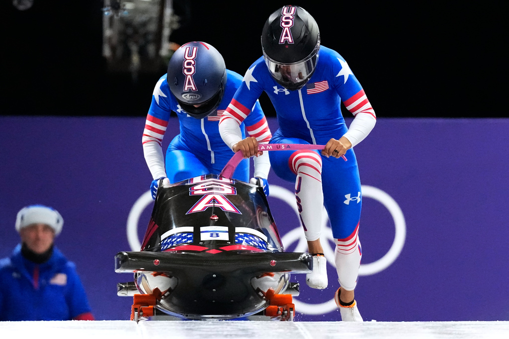 United States' Kaysha Love, right, and Azaria Hill start for a two women bobsled run at the 2026 Winter Olympics, in Cortina d'Ampezzo, Italy, Saturday, Feb. 21, 2026. (AP Photo/Aijaz Rahi)