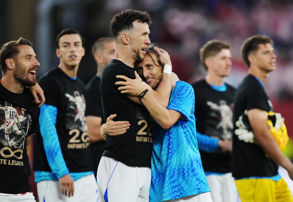 Croatia's Luka Modric, center right, celebrates with Ivan Perisic after defeating Panama as teammates wear shirts honouring his 200th appearance for Croatia following a World Cup Group L soccer match, in Toronto, on Tuesday, June 23, 2026. (Nathan Denette/The Canadian Press via AP)
