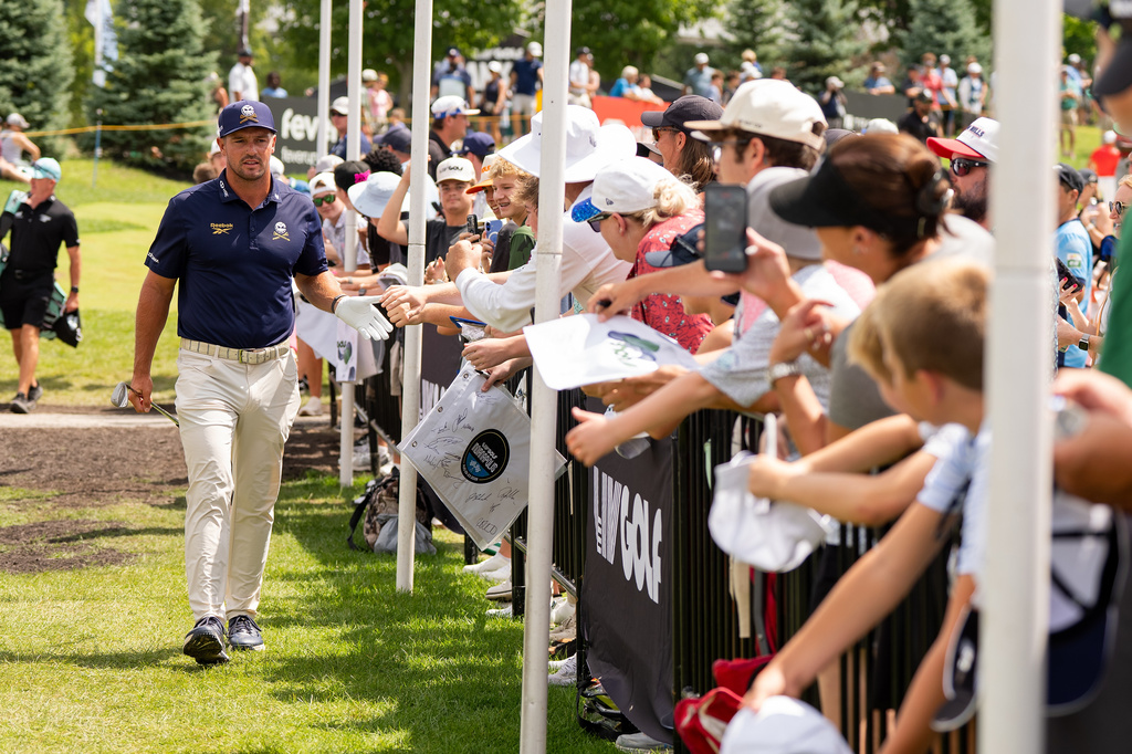 Captain Bryson DeChambeau, left, of Crushers GC, greets fans before the final round of LIV Golf Indianapolis, Sunday, Aug. 23, 2026, in Westfield, Ind. (Pedro Salado/LIV Golf via AP)