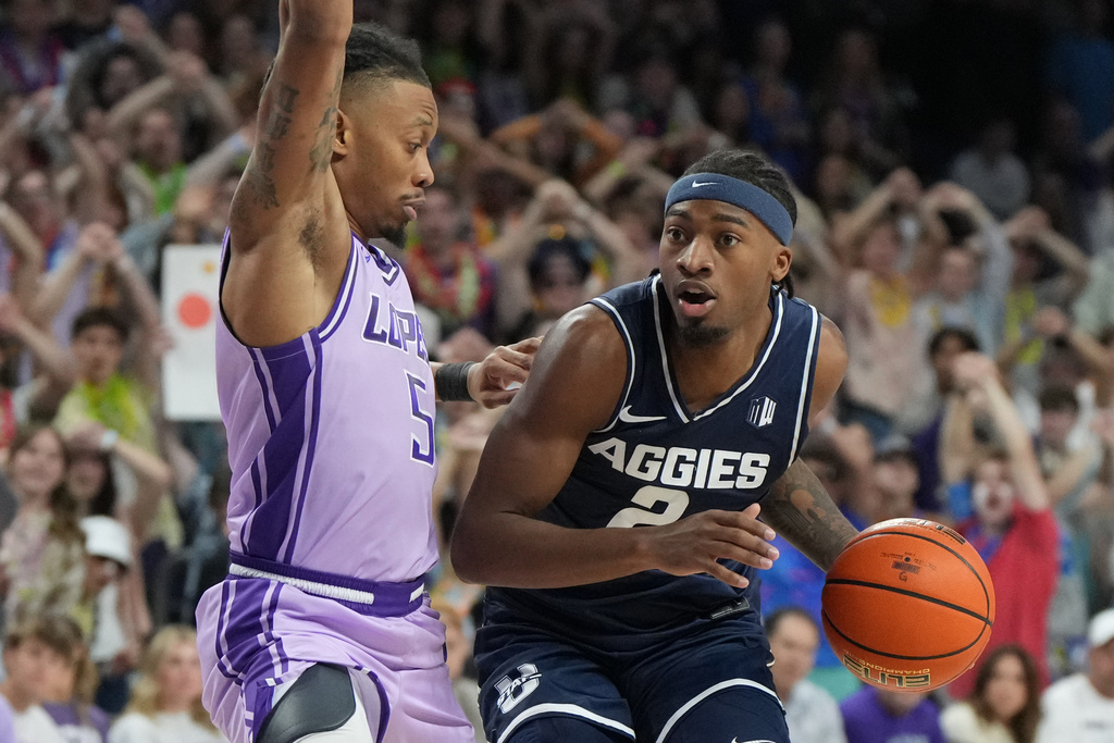 Utah State guard Mj Collins drives on Grand Canyon guard Brian Moore Jr. (5) during the first half of an NCAA college basketball game, Saturday, Jan. 17, 2026, in Phoenix. (AP Photo/Rick Scuteri)