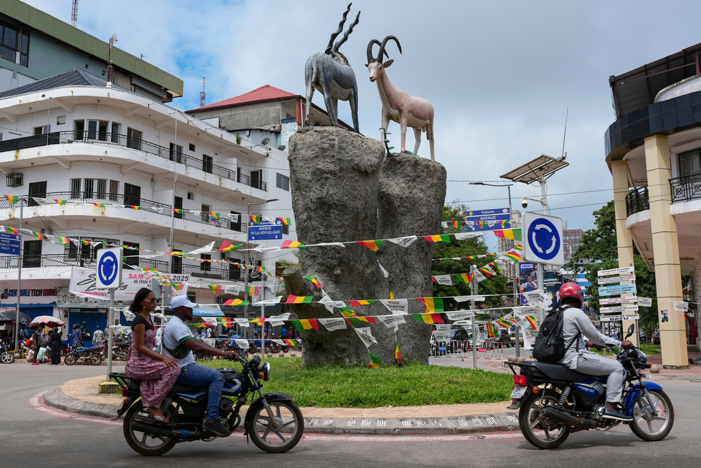 Motorcycles travel through a roundabout in Conakry, Guinea, Friday, Sept. 19, 2025. (AP Photo/Misper Apawu)