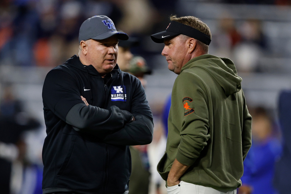 Kentucky head coach Mark Stoops talks with Auburn head coach Hugh Freeze before an NCAA college football game, Saturday, Nov. 1, 2025, in Auburn, Ala. (AP Photo/Butch Dill)
