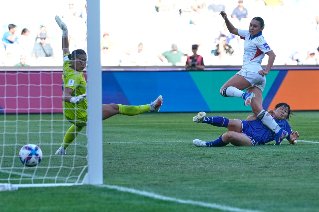 Japan's Remina Chiba, bottom right, scores her team's third goal during the Women's Asian Cup quarterfinal soccer match between Japan and the Philippines in Sydney, Sunday, March 15, 2026. (AP Photo/Rick Rycroft)