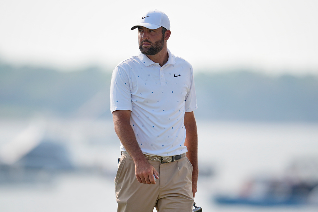 Scottie Scheffler walks across the 18th green during the third round of the RBC Heritage golf tournament Saturday, April 18, 2026, in Hilton Head, S.C. (AP Photo/Mike Stewart)