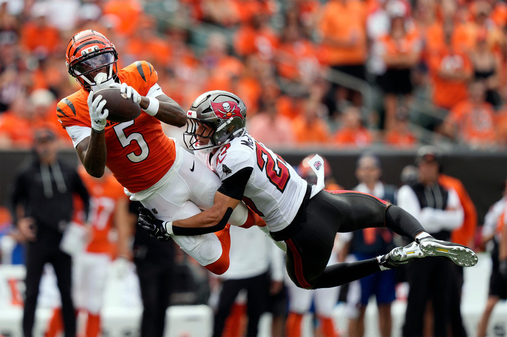 Cincinnati Bengals wide receiver Tee Higgins (5) catches a pass as he is defended by Tampa Bay Buccaneers cornerback Zyon McCollum (27) in the second half of an NFL football game Sunday, Sept. 13, 2026, in Cincinnati. (AP Photo/Carolyn Kaster)