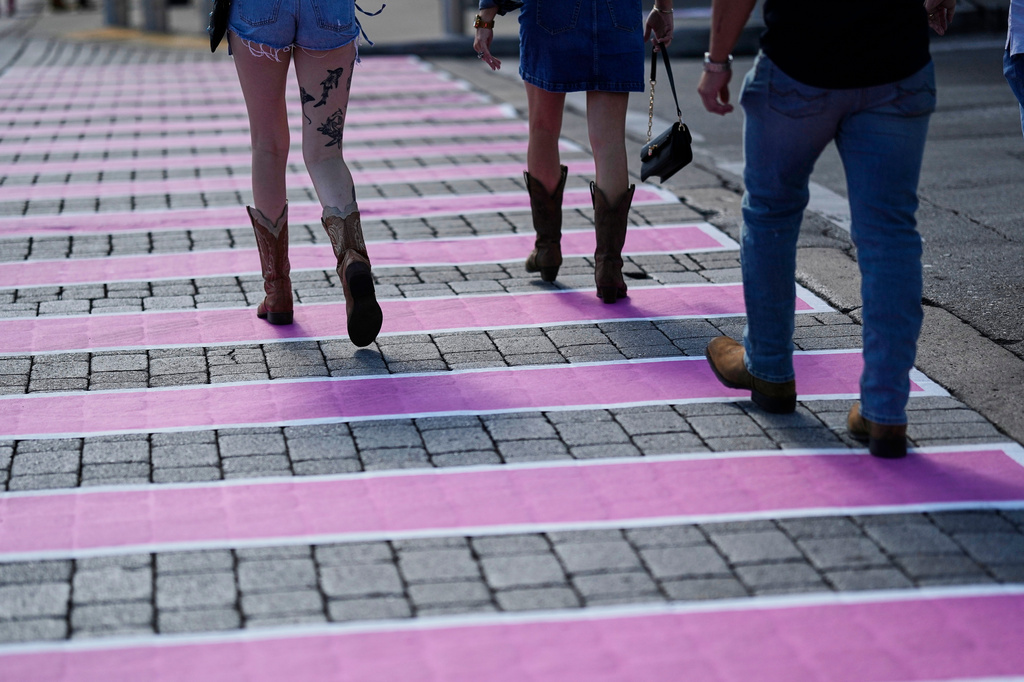 People make their way across a pink crosswalk during Dolly Parton Day honoring the late country music artist Friday, Sept. 25, 2026, in Nashville, Tenn. (AP Photo/George Walker IV)