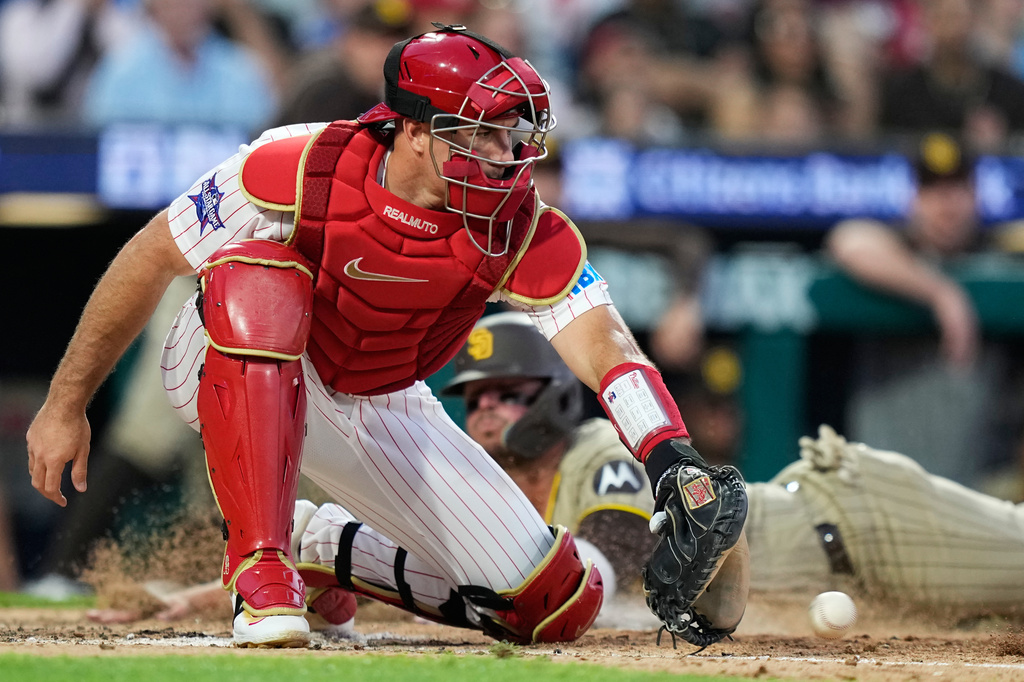 San Diego Padres' Ty France scores past Philadelphia Phillies' J.T. Realmuto on a run-scoring single by San Diego Padres' Jackson Merrill during the seventh inning of a baseball game Wednesday, June 3, 2026, in Philadelphia. (AP Photo/Matt Slocum)