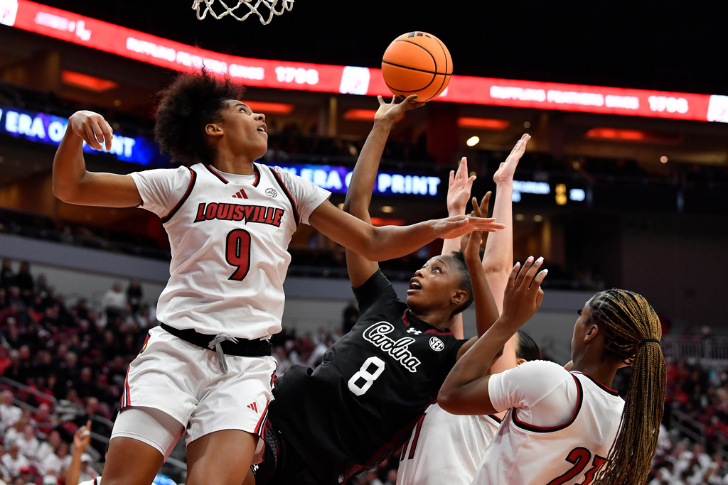 South Carolina forward Joyce Edwards (8) attempts a shot over Louisville forward Anaya Hardy (9) during the second half of an NCAA college basketball game in Louisville, Ky., Thursday, Dec. 4, 2025. (AP Photo/Timothy D. Easley)