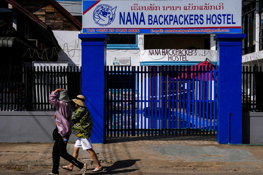 FILE -Foreign tourists walk past the closed Nana Backpackers hostel in Vang Vieng, Laos, Nov. 23, 2024. (AP Photo/Anupam Nath, File)
