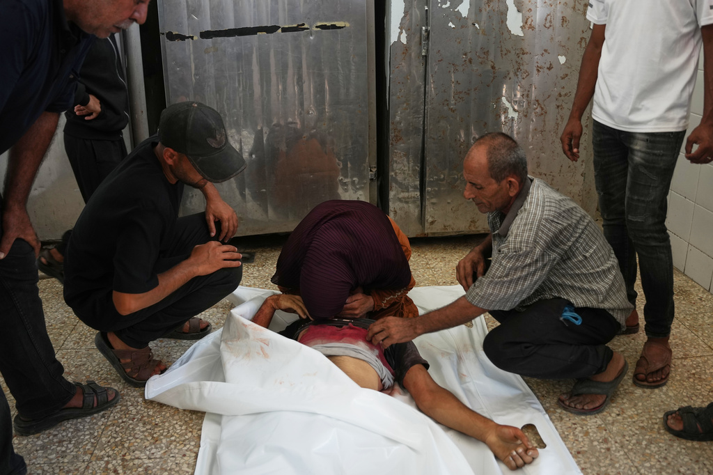 Palestinian mourners cry over the body of Hamouda al-Attar, who was killed by the Israeli army, during his funeral at al-Aqsa Hospital in Deir al-Balah, central Gaza Strip, Saturday, Aug. 29, 2026. (AP Photo/Abdel Kareem Hana)