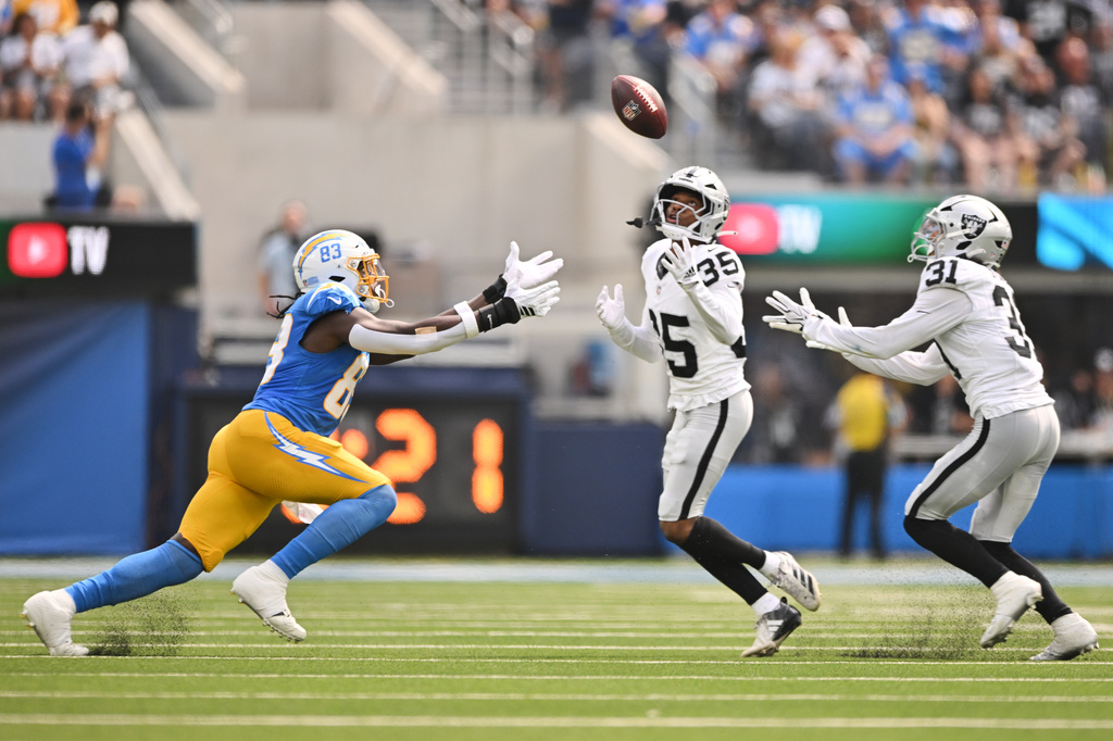 Las Vegas Raiders cornerback Hezekiah Masses (35) intercepts a pass intended for Los Angeles Chargers tight end David Njoku (83) during the first half of an NFL football game in Inglewood, Calif., Sunday, Sept. 20, 2026. (AP Photo/Katie Chin)