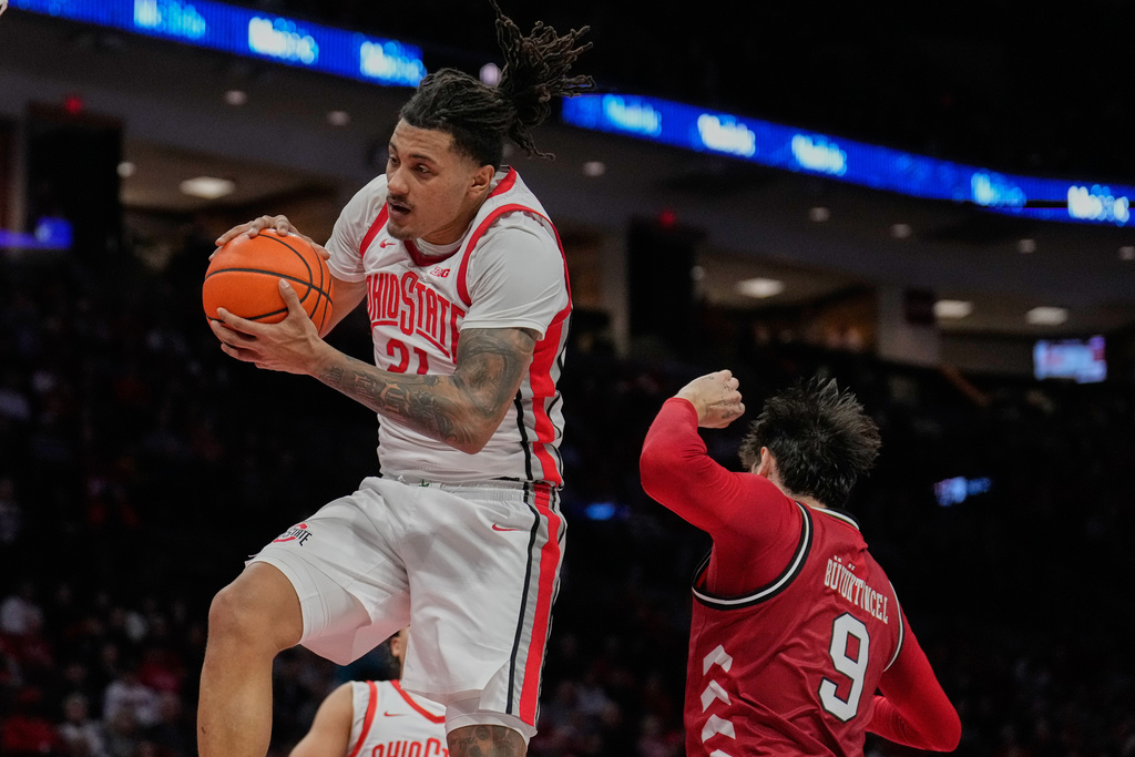 Ohio State forward Devin Royal (21) grabs a rebound next to Nebraska forward Berke Buyuktuncel (9) in the first half of an NCAA college basketball game Monday, Jan. 5, 2026, in Columbus, Ohio. (AP Photo/Sue Ogrocki)