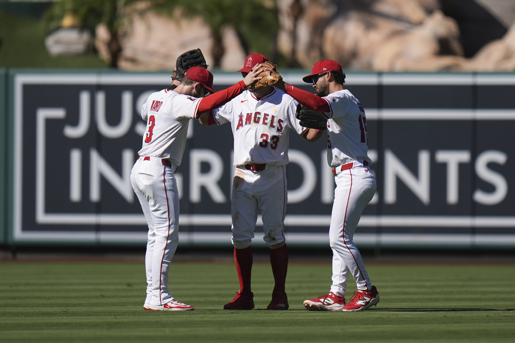 Los Angeles Angels' Taylor Ward (3), Chris Taylor (33) and Matthew Lugo (15) celebrate the team's win in a baseball game against the Athletics Sunday, Sept. 7, 2025, in Anaheim, Calif. (AP Photo/Jae C. Hong)