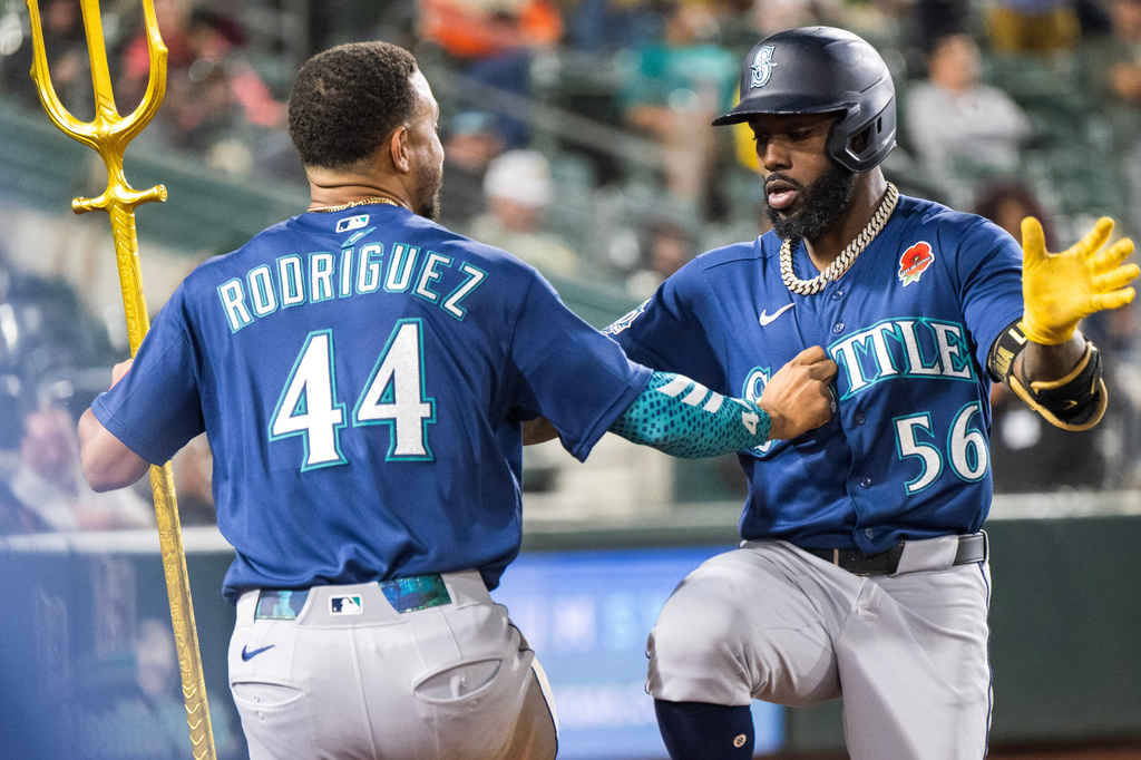 Seattle Mariners' Randy Arozarena (56) celebrates with Julio Rodríguez (44) after Arozarena hit a home run during the ninth inning of a baseball game against the Athletics in West Sacramento, Calif., Monday, May 25, 2026. (AP Photo/Nic Coury)