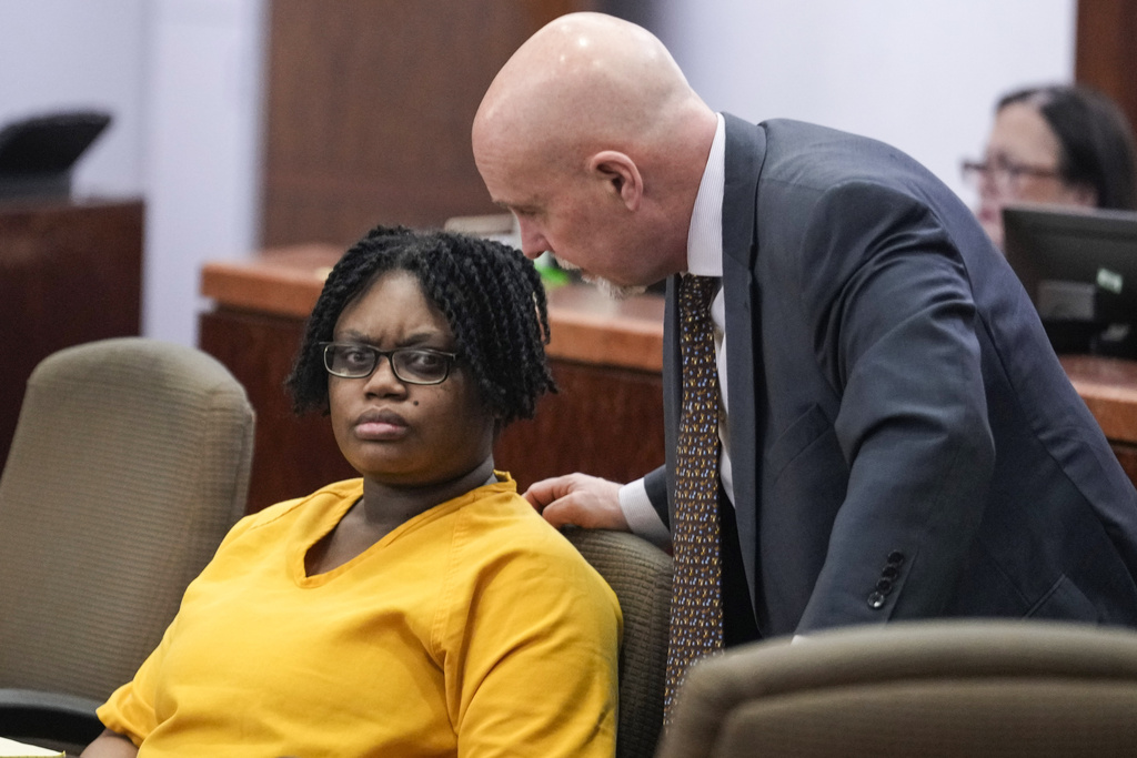 Defendant Gloria Williams, charged in connection with the death of her 8-year-old son, whose skeletal remains decomposed for months inside a Houston-area apartment with three surviving but abandoned siblings, listens to one of her lawyers Neal Davis III, during a hearing Tuesday, Nov. 12, 2024, at the Harris County Criminal Justice Center in Houston. (Brett Coomer/Houston Chronicle via AP)