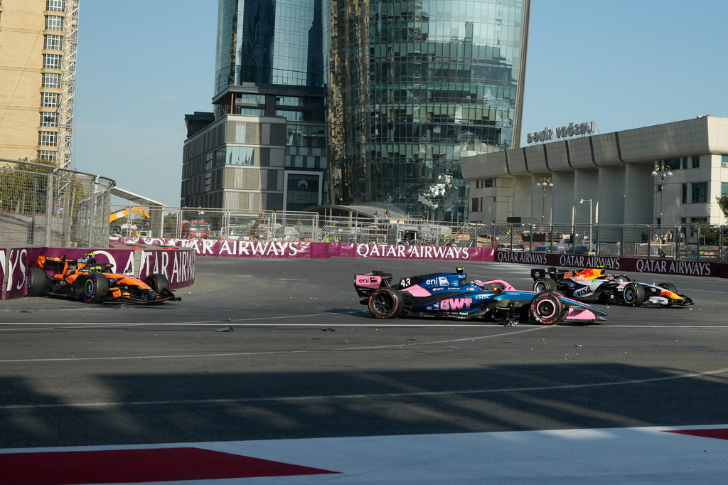 Alpine driver Franco Colapinto of Argentina, center, crashes with McLaren driver Lando Norris of Britain, left, and Racing Bulls driver Liam Lawson of New Zealand during the Azerbaijan F1 Grand Prix auto race, in Baku, Azerbaijan, Saturday, Sept. 26, 2026. (AP Photo/Darko Bandic)