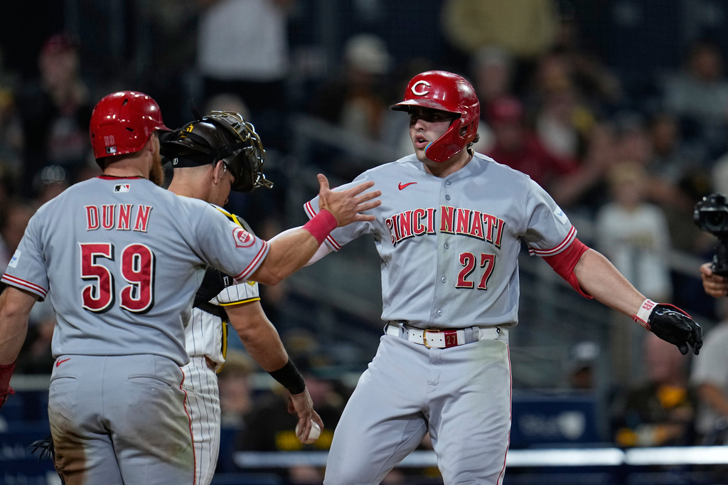 Cincinnati Reds' Sal Stewart (27) celebrates with teammate Blake Dunn (59) after hitting a two-run home run during the eleventh inning of a baseball game against the San Diego Padres Tuesday, June 9, 2026, in San Diego. (AP Photo/Gregory Bull)
