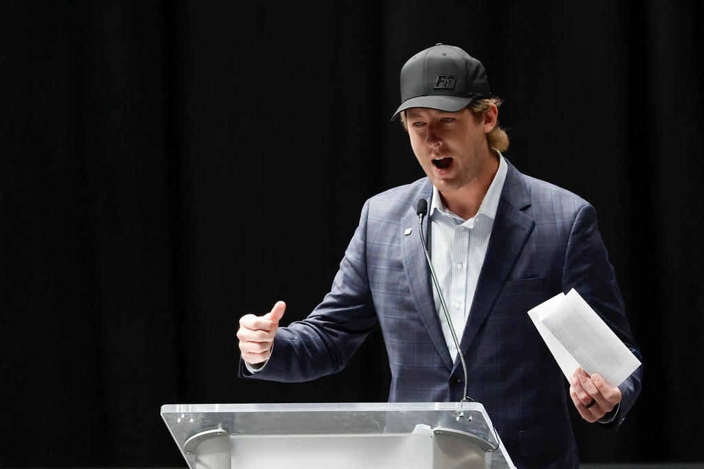 Garrett Mitchell speaks at the memorial service for former NASCAR driver Greg Biffle and his family in Charlotte, N.C., Friday, Jan. 16, 2026. (AP Photo/Nell Redmond)