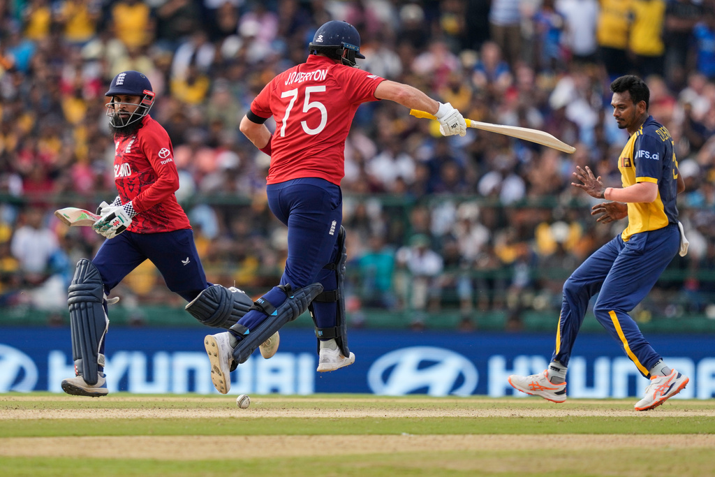 England's Adil Rashid, left, and Jamie Overton run between the wickets during the T20 World Cup cricket match between Sri Lanka and England in Pallekele, Sri Lanka, Sunday, Feb. 22, 2026. (AP Photo/Eranga Jayawardena)