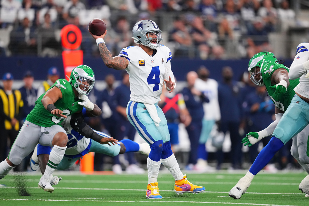 Dallas Cowboys quarterback Dak Prescott (4) throws a pass during the first half of an NFL football game against the Philadelphia Eagles, Sunday, Nov. 23, 2025, in Arlington, Texas. (AP Photo/Julio Cortez)