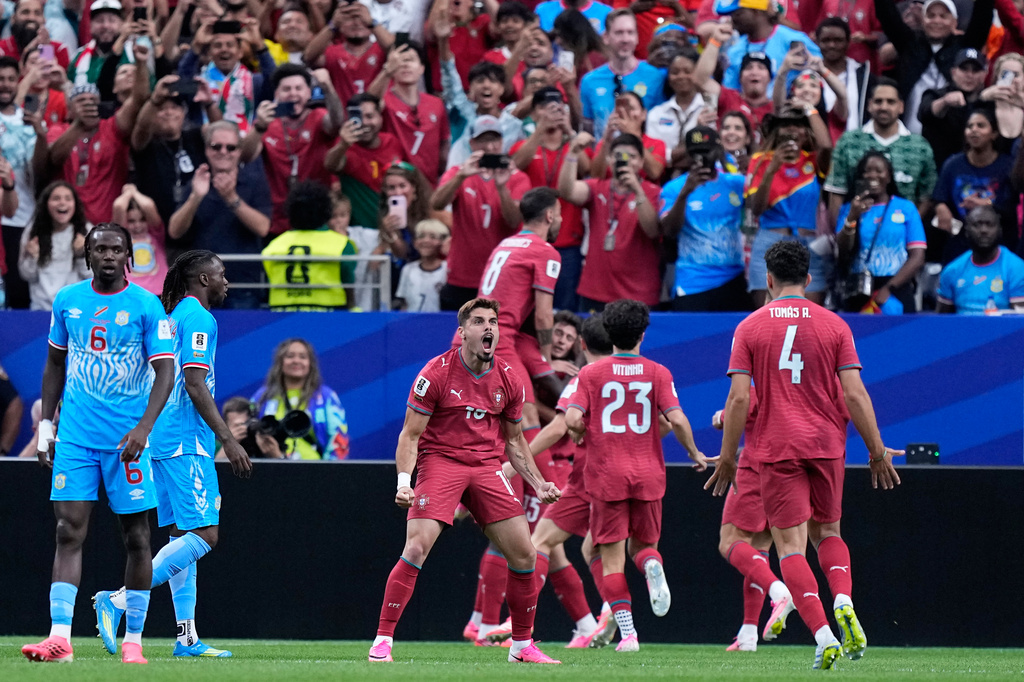 Portugal's Pedro Neto, center, celebrates after teammate Joao Neves scored the opening goalduring the World Cup Group K soccer match between Portugal and Congo in Houston, Wednesday, June 17, 2026. (AP Photo/Ashley Landis)