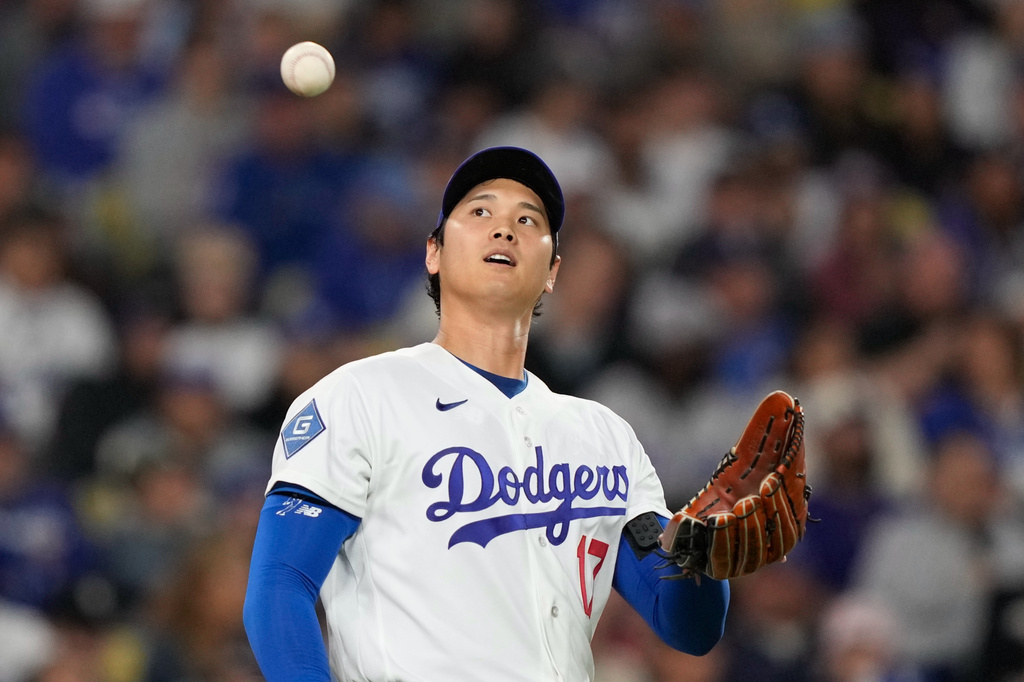 Los Angeles Dodgers starting pitcher Shohei Ohtani takes a new ball after Miami Marlins' Christopher Morel scored on a single by Kyle Stowers during the fifth inning of a baseball game Tuesday, April 28, 2026, in Los Angeles. (AP Photo/Mark J. Terrill)
