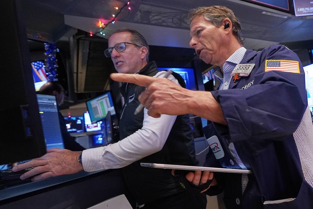 Specialist Glenn Carell, left, and trader Robert Charmak work on the floor of the New York Stock Exchange, Thursday, Dec. 11, 2025. (AP Photo/Richard Drew)