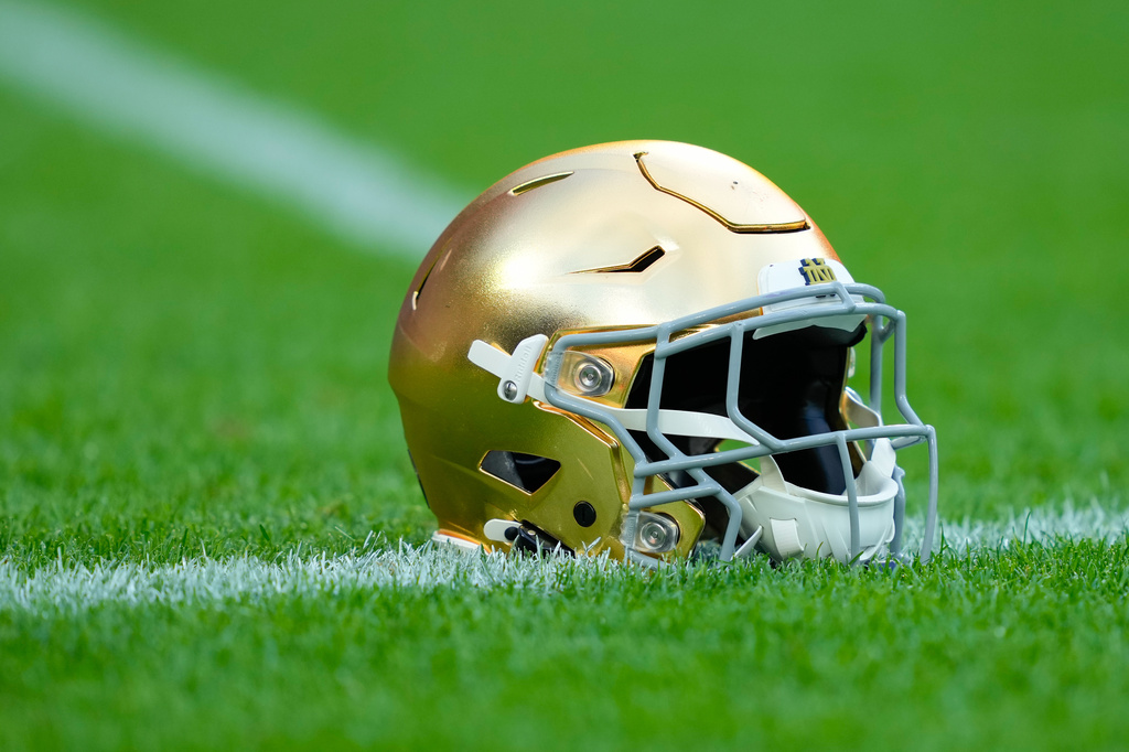 FILE - A Notre Dame helmet rests on the ground before an NCAA college football game against Wisconsin on Sept. 6, 2026, in Green Bay, Wis. (AP Photo/Kayla Wolf, File)