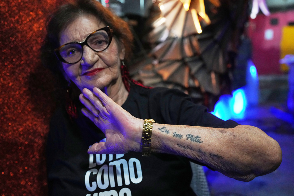 Former sex worker Lourdes Barreto shows a tattoo that reads in Portuguese, "I am a whore," at the Porta da Pedra samba school in Rio de Janeiro, Monday, Feb. 9, 2026. (AP Photo/Silvia Izquierdo)