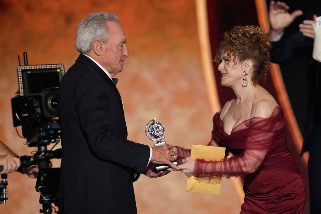 Bernadette Peters, left, presents the award for best musical to Lorne Michaels for "Schmigadoon!" during the 79th Tony Awards on Sunday, June 7, 2026, at Radio City Music Hall in New York. (Photo by Charles Sykes/Invision/AP)