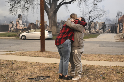 Lisa Diaz hugs a neighbor outside of their homes as the Eaton Fire sweeps through the area Wednesday, Jan. 8, 2025, in Altadena, Calif. (AP Photo/Nic Coury) Lisa Diaz hugs a neighbor outside of their homes as the Eaton Fire sweeps through the area Wednesday, Jan. 8, 2025, in Altadena, Calif. (AP Photo/Nic Coury)