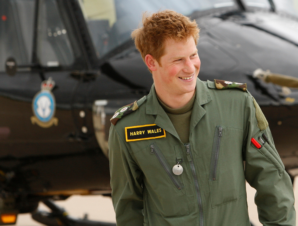 FILE - In this Thursday, June 18, 2009 file photo Britain's Prince Harry smiles during a photo call at RAF (Royal Air Force) Shawbury in Shropshire, England. (AP Photo/Kirsty Wigglesworth, File)