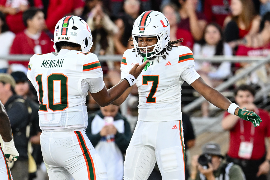 Miami wide receiver Daylyn Upshaw (7), right, reacts with quarterback Darian Mensah (10) after scoring a touchdown against Stanford during the first half of an NCAA college football game Friday, Sept. 4, 2026, in Stanford, Calif. (AP Photo/Thien-An Troung)